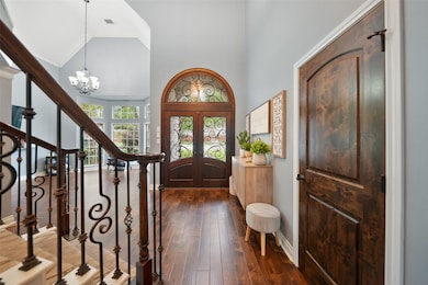 The inviting foyer features a high ceiling, elegan