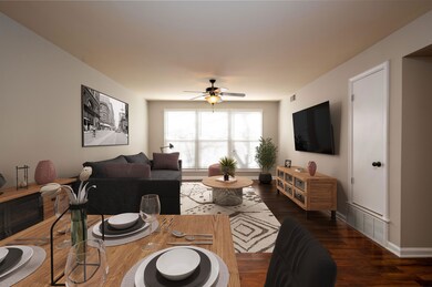 Living room with ceiling fan and dark hardwood / w