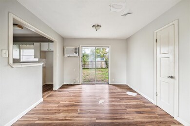 The open living/dining area features laminate floo