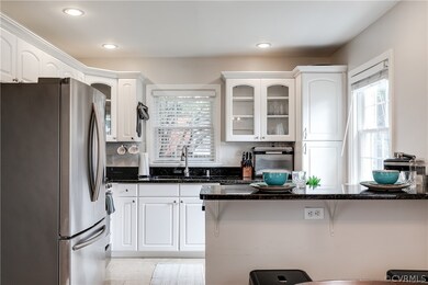 Kitchen with stainless steel fridge, white cabinet