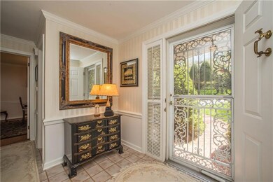 The front entry has an elegant wrought iron storm 