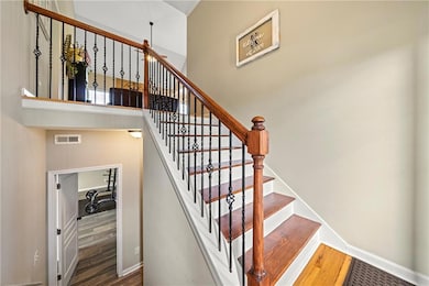 Stairway featuring wood finished floors and baseboards