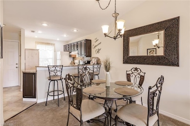 Dining space featuring light carpet and a notable 