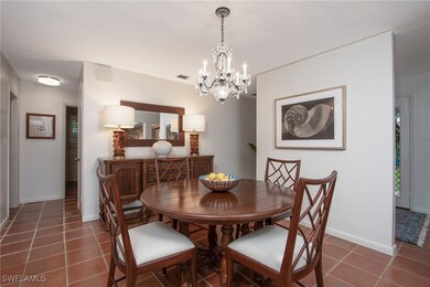 Tiled dining room featuring a notable chandelier