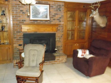 Den with brick fireplace