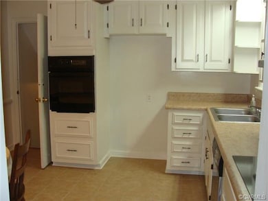 The kitchen is updated with ceramic flooring and n