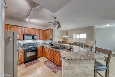 Kitchen featuring black appliances, a breakfast ba