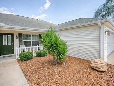 LOW MAINTENANCE SHRUBS AND PALMS ARE SURROUNDED WI
