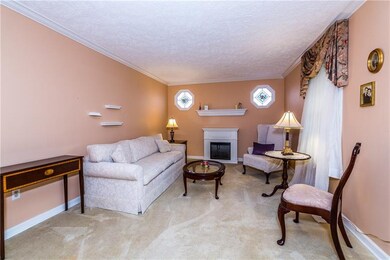 Living room has an electric fireplace to keep you 