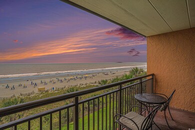 Balcony with view of water and beach