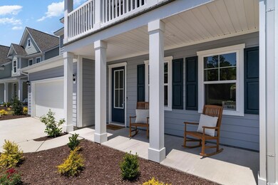 Exterior space featuring covered porch, a garage, 