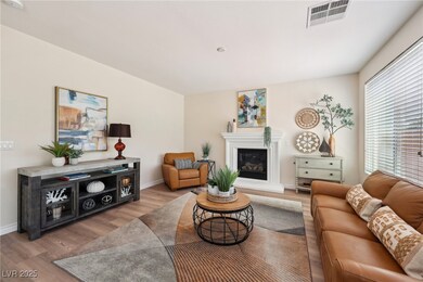 Living room with wood finished floors, a glass cov
