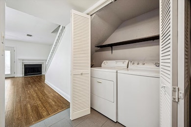 Washroom featuring light wood finished floors, a 