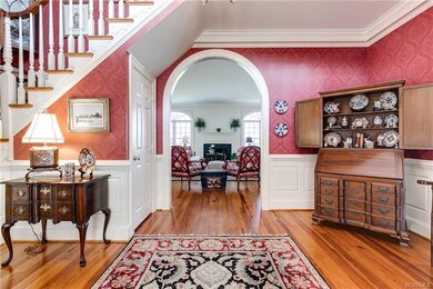 Welcoming foyer has arched entrance to the enterta