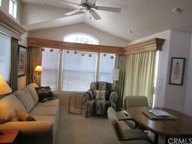 Living Room with Ceiling Fan and Cathedral Ceiling