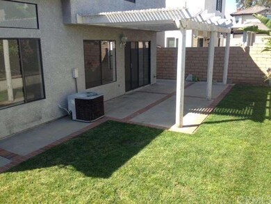 Large backyard with patio cover.