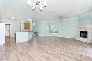 Unfurnished living room featuring a chandelier, a