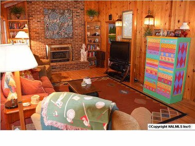 Reverse view of the living room and fireplace.