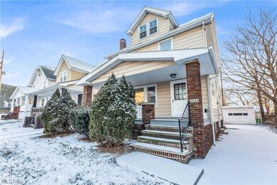 View of front of home with a garage and covered porch