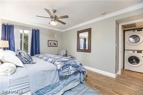 Bedroom featuring crown molding, wood-type floorin