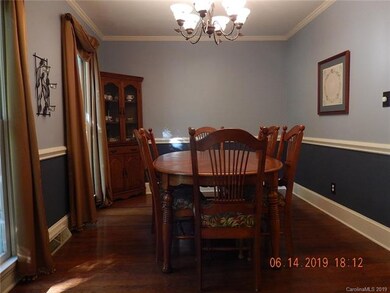 Formal dining room with chair railing and crown molding