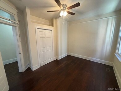 Unfurnished bedroom with a closet, dark wood-type