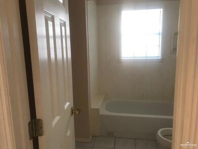 Bathroom with toilet, tile flooring, and shower / bathing tub combination
