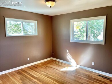 Empty room featuring visible vents, a wealth of na