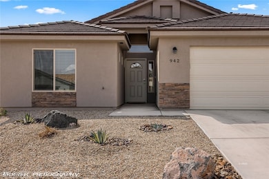 Entrance to property featuring stone siding, an at