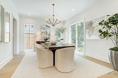 Impeccable formal dining exudes elegance featuring walls of floor to ceiling windows, gleaming oak hardwoods, and Ruhlmann chandelier. This dinging space is graciously sized to accommodate large furniture pieces and there is ample wall space for art.