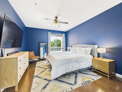 Bedroom featuring ceiling fan, baseboards, and wo
