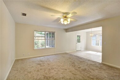 The great room has nice light and is open to the d