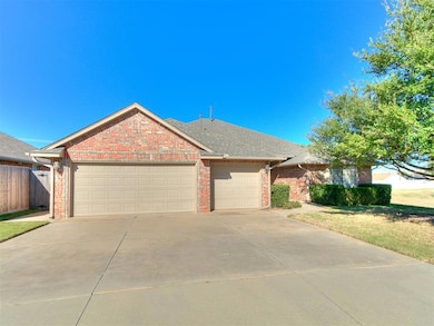 Ranch-style home featuring brick siding, concrete driveway, a garage, a shingled roof, and a front yard