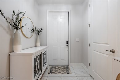 Foyer entrance with marble finish floor and basebo