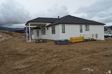 Back of property featuring a patio area and roof with shingles