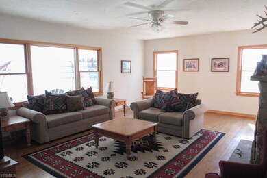 Living room with a picture window and wood floorin