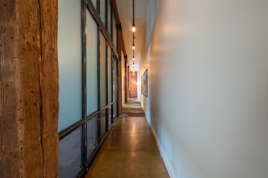Corridor featuring a towering ceiling