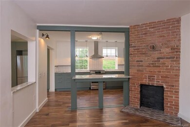 BRIGHT Living room opens to dining area/kitchen.