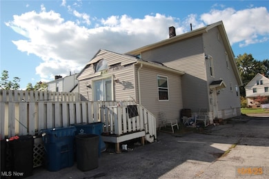 View of side of property featuring a wooden deck and a chimney