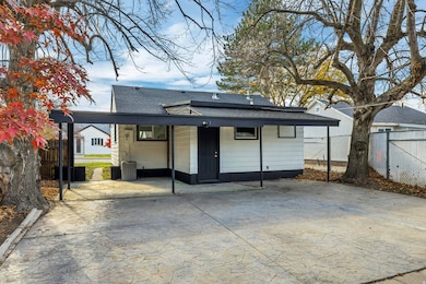 Rear view of property with roof with shingles and a porch