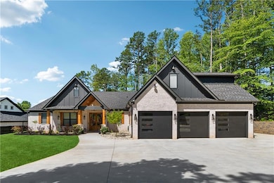 Modern farmhouse style home featuring board and batten siding, driveway, a front yard, brick siding, and an attached garage