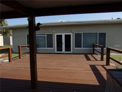 BACK OF HOME WITH LARGE DECK