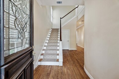Solid hardwood floors and soaring ceilings greet you at the entry.