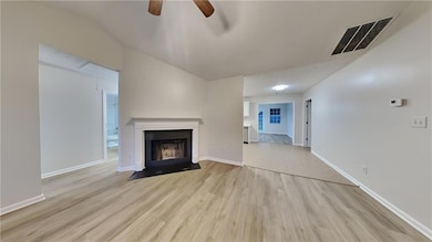 Unfurnished living room with visible vents, basebo