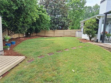 View of yard featuring a wooden deck and a fenced 