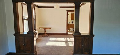 Hallway featuring light carpet, crown molding, and