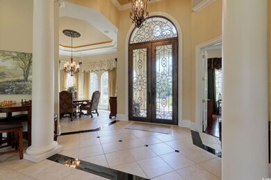 Tiled foyer entrance featuring decorative columns,