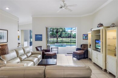 Living room with light tile flooring, crown moldin