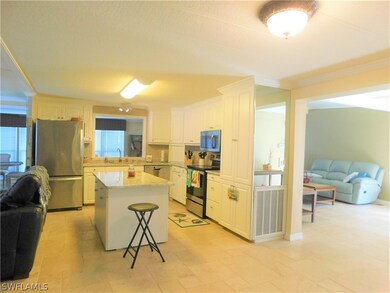 Wider view of the kitchen area. Home entrance is t