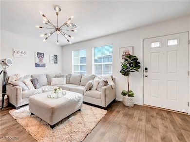 Living area featuring a chandelier, light wood fin